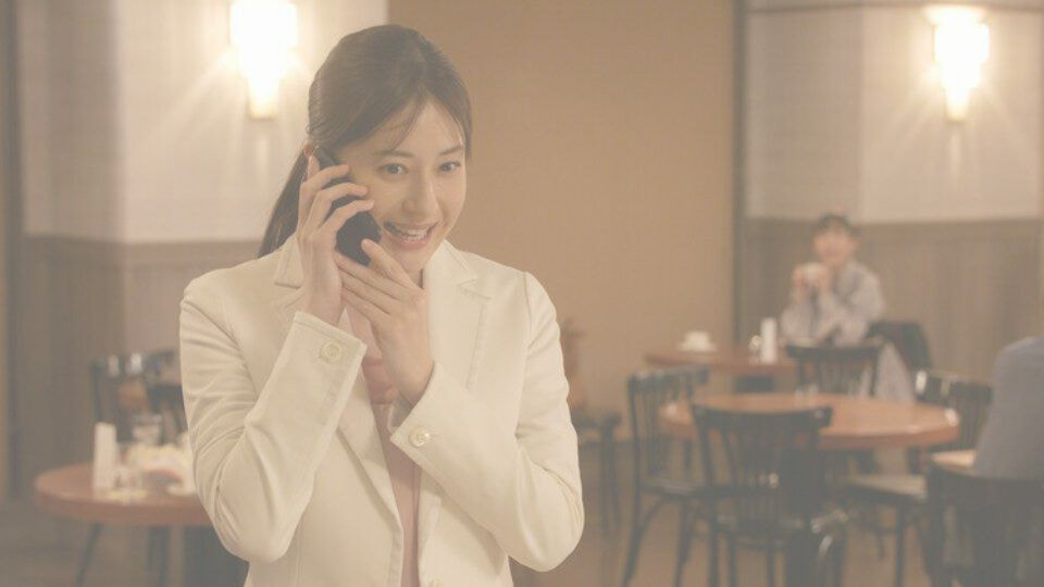 電話する女性とそれを遠目に見ている
